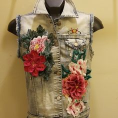 Gorgeous Sleeveless Distressed Light Wash Denim Vest. Brand New With Tags Never Worn. Boutique. Beautiful 3d Floral Appliques Attached To The Front. Functional Front Coin Pocket. 5 Button. Frayed At The Hemline And Sleeves. Distressed Patches On The Back. This Is European Sizing Please Check Your Measurements. Its Sized Large But It Would Fit Size 8/10. Measurements Laying Flat Armpit To Armpit Are 18 Inches. This Is On Trend!!! Super Cute!! Summer Cotton Denim Vest With Floral Embroidery, Spring Blue Recycled Denim Vest, Summer Embroidered Blue Denim Vest, Spring Button-up Denim Vest With Pockets, Spring Washed Denim Button-up Vest, Denim Applique, Floral Applique, Light Wash Denim, Denim Vest