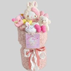 a stuffed animal in a pink basket filled with stuff animals and other items on a gray background