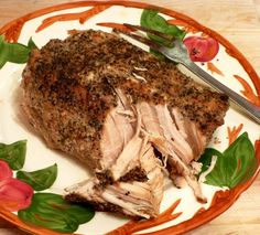 a piece of meat on a plate with a knife and fork next to the meat