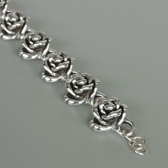 This is a beautiful sterling silver bracelet made with 8 rose links. Length: 7 inches Rose: 19 x 19mm Weight: 21.2gm This bracelet is made of 925 hypoallergenic sterling silver by the Electroform method. This piece is sent in a gift box. I can include a personal message from you if needed You are welcome to contact me at... bhavnakwintra1956@gmail.com For more beautiful pieces from my shop, please browse 👇 TOE RINGS: https://www.etsy.com/your/shops/TheSilverGame/tools/listings/section:27020628, Luxury Silver Jewelry With Rose Design, Bracelets Silver Rose, Affordable Sterling Silver Bracelet For Valentine's Day, Wrist Chain, Bracelet Wrist, Sterling Silver Bead Bracelet, Wrist Jewelry, Rose Bracelet, 925 Silver Bracelet