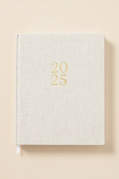 a white book with gold numbers on the front and back cover that reads, 205