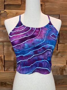 "- Hand tied and dyed - 93% Cotton 7% Elastane - Super stretchy fabric - Color fast This unique geode crop top was ice dyed with Procion dyes. It is a Women's XS. It has been machine washed twice and dried. Please note that colors may vary due to your devices display. *Wash with care* - Wash with like colors - Wash on gentle cycle with cold water - Tumble dry low or hang dry Measurements: Flat Lay Pit to pit: 12.5\" Length: 11.5\" If you have any questions please send me a message!" Fitted Bohemian Tops With Batik Print, Fitted Bohemian Batik Print Top, Fitted Tie Dye Crop Top For The Beach, Tie Dye Fitted Cotton Crop Top, Fitted Tie Dye Cotton Crop Top, Fitted Cotton Tie Dye Crop Top, Fitted Tops With Batik Print For Summer, Bohemian Tie Dye Crop Top, Purple Bohemian Crop Top For Summer