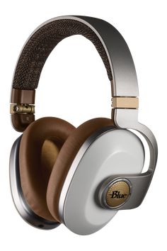 a pair of headphones with brown and silver trims on the top, one is closed