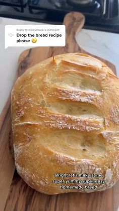 a loaf of bread sitting on top of a wooden cutting board