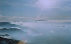 the sun shines brightly above some clouds in the sky as seen from an airplane