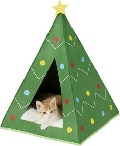 a cat is laying in a green christmas tree shaped tent with a yellow star on top