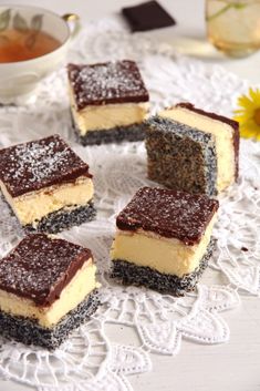 four pieces of cake sitting on top of a doily