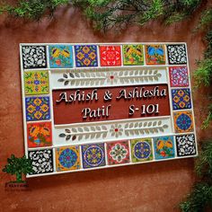 the sign for ashish and ashesha pattii is decorated with colorful tiles