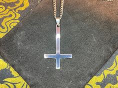 Dark times call for Darkness Jewelry. This custom-made Inverted Upside Down Cross Satanic Pendant Necklace is both timeless and retro. Perfect for minimalist Pagan Satanic symbolism. Pendant is designed for everyone and is stunning in its silver color and is a sight to behold! Chain is also stainless steel and silver in color. Show your support of The One behind all of this madness and be saved when He sets foot upon the land. Material: Stainless Steel, Steel Color: Silver Dimensions: Necklace l Symbolic Stainless Steel Cross Pendant Necklace, Symbolic Stainless Steel Cross Necklace, Adjustable Stainless Steel Cross Pendant Necklace, Minimalist Stainless Steel Cross Pendant Jewelry, Adjustable Stainless Steel Cross Necklace, Minimalist Stainless Steel Cross Necklace With Adjustable Chain, Minimalist Silver Stainless Steel Cross Necklace, Modern Stainless Steel Cross Necklace For Gift, Symbolic Stainless Steel Cross Jewelry