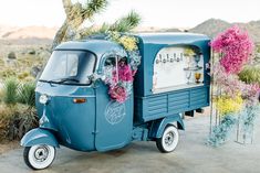 an ice cream truck decorated with flowers and greenery