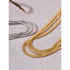 This necklace features a long, flat chain that mimics the sinuous movement of a snake, creating a tactile and visual appeal. The design is minimalist yet striking, with a smooth, reflective surface that glimmers in the light. Crafted from high-quality materials, the necklace is both durable and comfortable to wear. Its length makes it ideal for stacking with other necklaces for a layered look, or it can be worn alone as a statement piece. Metals Type: STAINLESS STEEL Material: Metal Style: TREND Minimalist Snake Chain Necklace With Adjustable Chain, Modern Herringbone Necklace With Delicate Chain, Minimalist Metal Snake Shape Chain Necklace, Minimalist Metal Snake-shape Chain Necklace, Adjustable Gold-plated Snake Chain Necklace, Gold-tone Tarnish Resistant Snake Chain Necklace, Snake-shaped Metal Necklace With Adjustable Chain, Gold Snake-shaped Metal Necklace, Stacked Necklaces