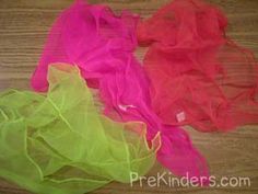 three different colored tulle sitting on top of a wooden table