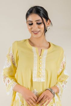 PRODUCT DETAIL: This bright and vibrant set comes laden with a beautiful cutwork embroidery. The lace detailing on the shirt and the tulip pants adds to the beauty of the outfit. *The length of the shirt can be customised. Contact us to get yours as per your preferences. SPECIFICATIONS: Color Yellow Fabric Cotton Product Code RANG18 White Cotton Cutwork Sets, Yellow Mulmul Sets With Printed Motifs, Yellow Long Sleeve Mulmul Set, Yellow Semi-stitched Lawn Suit With Resham Embroidery, Semi-stitched Yellow Sets With Cutdana Detail, Tulip Pants, Cutwork Embroidery, Boutique Dress Designs, Yellow Fabric