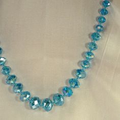 Iridescent Aquamarine Doublet Cut Crystals Beads Necklace Large Center Bead Size 15mm Across Wide Chain Length 30.5" To 33"Neckline. New Never Worn. Blue Faceted Round Bead Crystal Necklace, Adjustable Faceted Blue Crystal Necklace, Blue Faceted Crystal Necklace With Round Beads, Blue Faceted Round Bead Necklaces, Blue Faceted Necklaces With Round Beads, Blue Necklaces With Faceted Round Beads, Light Blue Round Bead Necklaces For Party, Light Blue Beaded Necklaces For Party, Elegant Blue Faceted Beaded Necklace