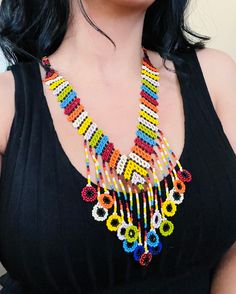 A vibrant and colorful necklace to enhance your style.🏵 Traditional Colorful Beads Necklace For Summer, Multicolor Beaded Chain For Festival, Colorful Adjustable Vibrant Necklace, Unique Multicolor Beaded Necklaces For Beach, Round Beaded Necklaces For Festivals, Unique Multicolor Necklaces For The Beach, Vibrant Rainbow Jewelry With Colorful Design, Colorful Beaded Chain Beads For Festival, Colorful Adjustable Beaded Necklaces With Polished Beads