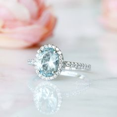 Beautiful Vintage Inspired Aquamarine Ring ►Made of solid sterling silver, rhodium plated (925) ►Accented with simulated diamonds (CZ) ►This ring can be paired with one or two matching milgrain bands of your choice (select option from the drop-down menu). Main Stone: Aquamarine Stone Cut: Oval Gem size: 8.0 x 6.0 mm Carat Weight: 1.21 ct. Stone Creation: Lab-Created ►Matching earrings can be purchased at: https://www.etsy.com/listing/699585734/oval-aquamarine-earrings-aquamarine-stud?ref=listing Oval Aquamarine Promise Ring, Aquamarine Wedding Diamond Ring With Halo Setting, Wedding Diamond Ring With Aquamarine Halo Setting, Oval Aquamarine Diamond Ring Gift, Oval Aquamarine Diamond Ring As Gift, Oval Aquamarine Birthstone Ring For Anniversary, Oval Aquamarine Anniversary Birthstone Ring, Fine Jewelry Aquamarine Promise Rings, Classic Aquamarine Diamond Ring With Prong Setting