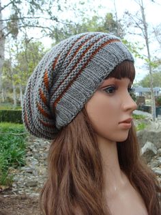 a mannequin head wearing a gray and orange knitted hat with stripes on it