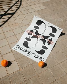 there is a sign on the ground with oranges around it