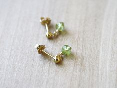 These gemstone earrings feature natural 4mm (1/8 inch) Peridot faceted spheres wire wrapped in 14k Gold Fill. These natural peridot earrings measure about 1/2 inch from the bottom of the drop to the top of their 14k Gold Fill studs. Create a matching set by looking through the rest of my peridot collection: https://www.etsy.com/shop/ThePeachTree?search_query=peridot Stone Properties: Peridot is a cleansing stone, alleviating negative thoughts and energy. It is a motivating stone, allowing for gr Green Briolette Earrings For Pierced Ears, Lime Green Peridot Earrings As Gift, Yellow Gold Peridot Earrings For Gift, Peridot Lime Green Earrings For Gift, Peridot Earrings Studs, Nickel-free Round Peridot Earrings, Cleansing Stones, Peridot Earrings, Peridot Stone