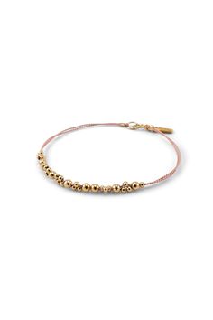 Our Leo Major Bracelet is a two-stranded silk cord adorned with an extended segment of detailed gold beadwork. 14k gold-filled beads and findings, silk cord. Complimentary gift packaging - handmade jewelry by Abacus Row in San Francisco California USA - bipoc