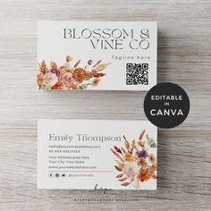 two business cards sitting on top of a wooden table with the words blooming vine co