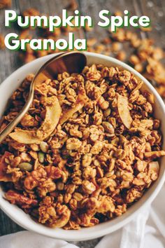 a white bowl filled with granola on top of a wooden table