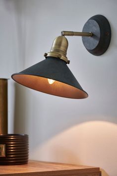 an old fashioned wall light is on the wall