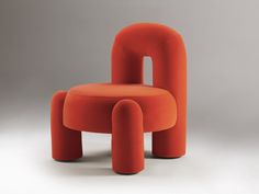 an orange chair and ottoman sitting next to each other