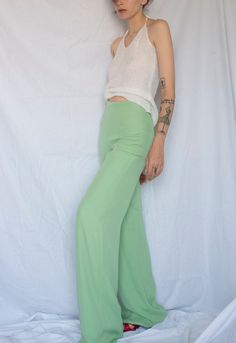 1990s Gianfranco Ferré Silk Wide Leg Pants in Pastel Green  Gianfranco Ferré Studio Made in Italy High waist  Back zipper Fully lined Gorgeous color and shape Best quality and fit Dream designer silk pants Forever piece and so versatile Very good condition Fits : S but check the measurements, ideally for tall people or you can professionally sewing it (model wearing XS  and she is 1,68 cm) (marked IT 42) Material : 52% acetate , 28% polyamide , 20% Silk In garment laying flat  Waist 33 cm  Rise Stretch Straight Leg Rayon Bottoms, Stretch Rayon Straight Leg Bottoms, Stretch Rayon Straight Leg Pants, Fitted Wide Leg Dress Pants For Summer, Chic Fitted Rayon Pants, Fitted Rayon Wide Leg Pants For Summer, Fitted Casual Rayon Pants, High Waist Stretch Green Dress Pants, Green Stretch High Waist Dress Pants