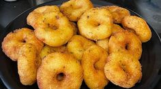 fried doughnuts in a black bowl on a table