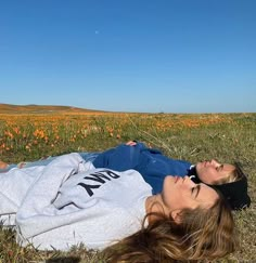 a woman laying in the grass with her eyes closed