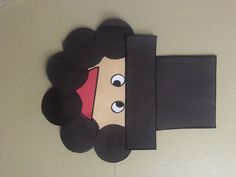 a paper cut out of a woman's face with black hair and big eyes