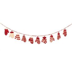 red and white mittens hanging from a string