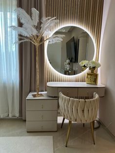 an elegant dressing table with a mirror, stool and palm tree in front of it