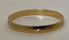 Monet gold plated brushed, textured, etched bangle bracelet.  marked: copyright symbol Monet S  diameter - 2 3/8" ; 7 mm. width.   Excellent condition, vintage.  1098 03/24/23 Copyright Symbol, Last Minute Gifts, Bangle Bracelet, Etching, Bangle Bracelets, Jewelry Bracelets, Gold Plate, Bangles, Plating