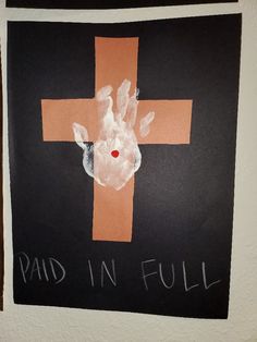 a cross painted on the side of a wall next to a handprinted deer