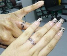 two hands with different designs on their fingers