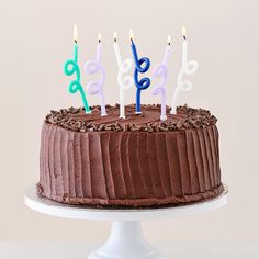 a birthday cake with chocolate frosting and lit candles