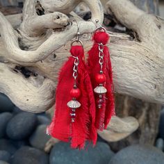 "These beautiful boho inspired earrings are hand-crafted using recycled sari silk and a variety of glass and seed beads.  They are very lightweight and the perfect addition for a casual day or fun night on the town Materials: Sari Silk/Glass, Wood & Metal Beads/Nickel Free Earwire Color: Red Measurements: Drop length approx. 2 3/4\"/Tassel 2\" Weight : 1 gram/.07 oz. (individual earring) Designer: Norma Patridis *Each set of earrings comes boxed ready for gifting* Please note that color may slig Beach Earrings With Latkans, Bohemian Beaded Earrings With Latkans For Beach, Bohemian Beaded Latkans Earrings For Beach, Bohemian Beaded Latkan Earrings For Beach, Bohemian Latkans Earrings For Beach, Bohemian Beaded Earrings With Latkans For Summer, Red Fringe Tassel Earrings For Summer, Bohemian Red Beaded Earrings Gift, Handmade Bohemian Tassel Earrings For Beach