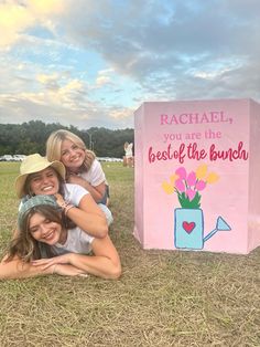 three girls are posing in front of a sign that says rachel, you are the best of the bunch