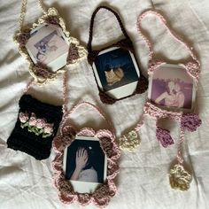 four handmade purses are arranged on a white sheet with pink and brown crochet