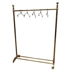 a metal rack with four hooks on it