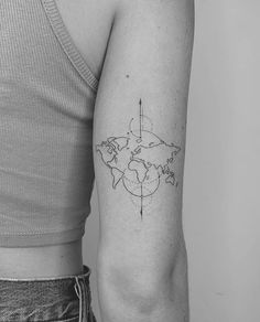 a woman's arm with a world map tattoo on it