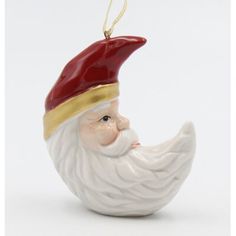 a ceramic ornament with a red hat and beard