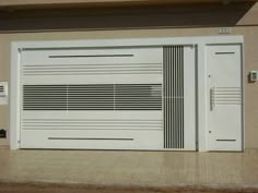 a white garage door sitting on the side of a building