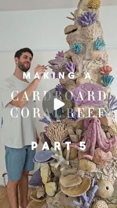 a man standing next to a pile of seashells