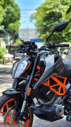 an orange and black motorcycle parked on the street