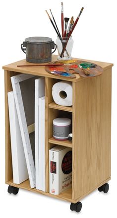 a small wooden cabinet with various items on it's shelf and some paintbrushes