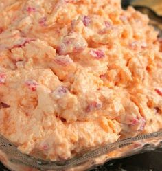 a close up of a bowl of food with crackers in the background