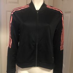 Sporty And Sophisticated Full Zip Jacket By Adidas! In A Versatile Festive Black And Iconic Pinky Peach Stripes Down The Arms, This Jacket Has Sporty Style. Zip Pockets At The Sides Securely Store Essentials And Keep Your Hands Warm Without Adding Bulk. Banded Cuffs On The Sleeves, Waistband, And Neck And Embroidered Logo Show The High Quality. Climalite Technology Keeps You Cool, Dry, And Comfortable. Size Large (Armpit To Armpit: 20” Length: 21”) New With Tags! Adidas Zip Up, Reflective Jacket, Adidas Retro, Adidas Windbreaker, Black Windbreaker, Nylon Dress, Poncho Jacket, Adidas Track Jacket, Color Block Jacket